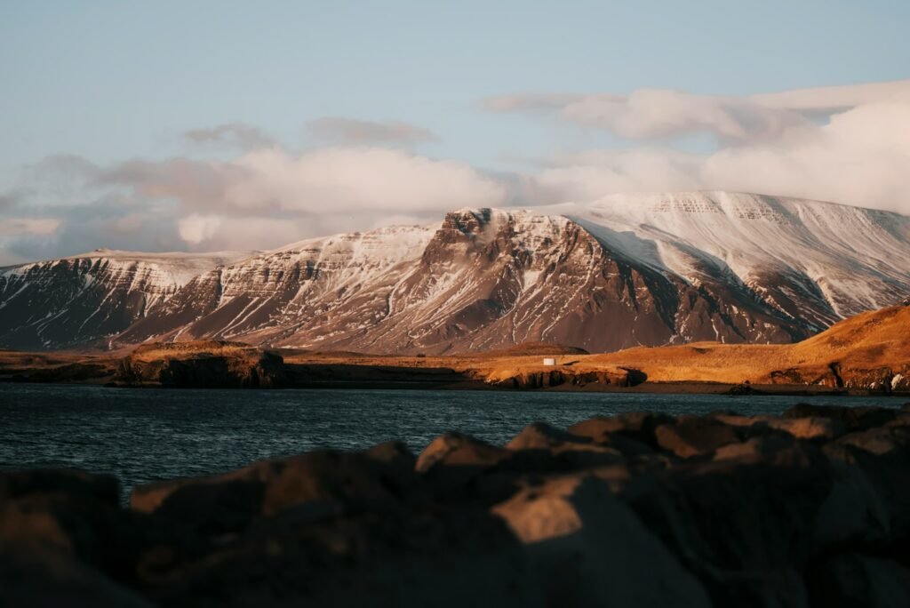 a mountain range with a body of water in front of it